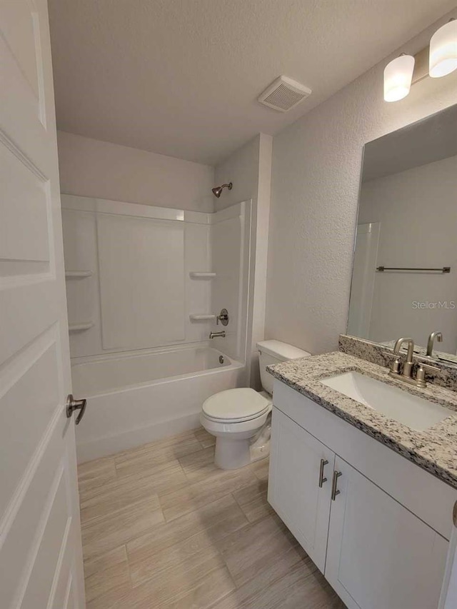 9553 SW 42nd Ave, Ocala, FL 34476 - full bathroom featuring a textured wall, vanity, toilet, tub / shower combination, and a textured ceiling