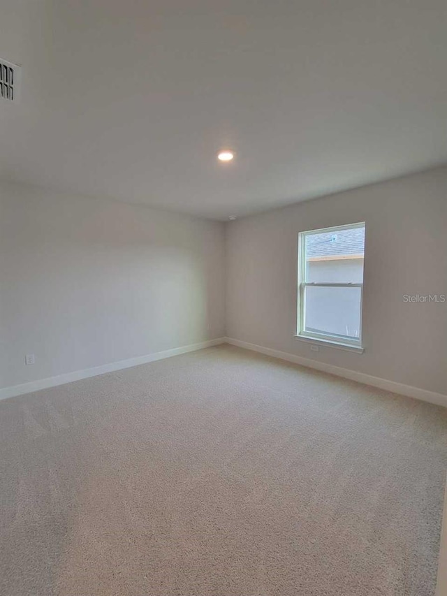 9553 SW 42nd Ave, Ocala, FL 34476 - spare room featuring light carpet, baseboards, and recessed lighting