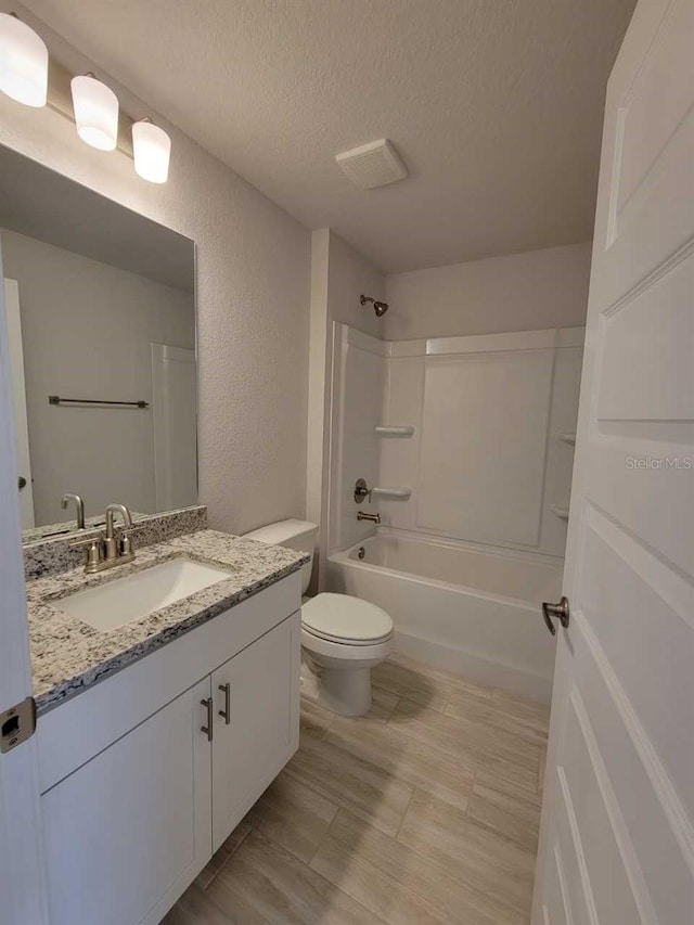 9553 SW 42nd Ave, Ocala, FL 34476 - full bath featuring vanity, a textured ceiling, toilet, a textured wall, and shower / bathtub combination