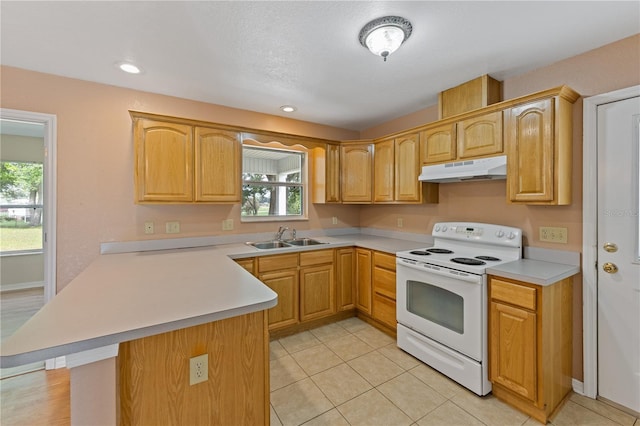 kitchen featuring a peninsula, light countertops, under cabinet range hood, a sink, and white range with electric cooktop