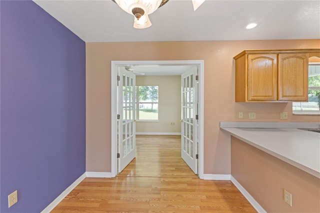 interior space with recessed lighting, light wood-style flooring, light countertops, and baseboards