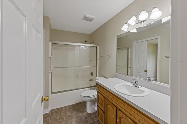 full bathroom with toilet, shower / bath combination with glass door, and vanity