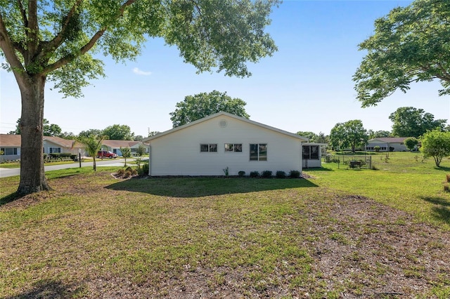 view of side of property featuring a yard