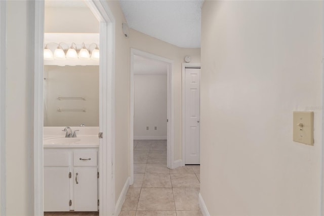 bathroom with tile patterned floors, vanity, and baseboards