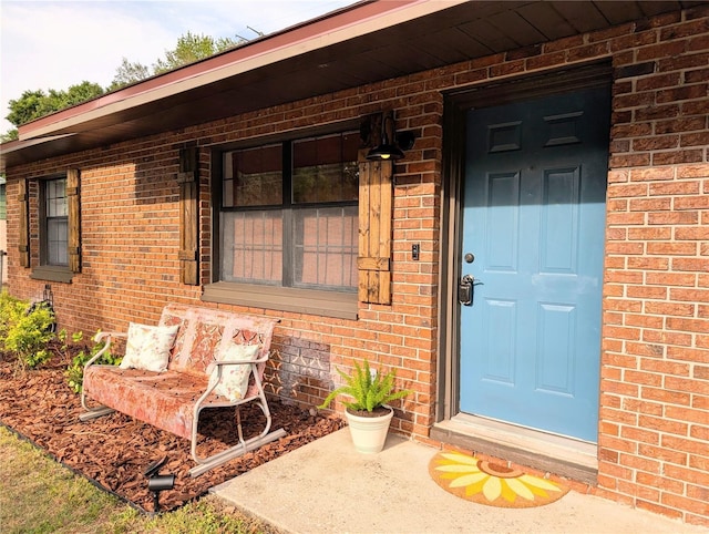 entrance to property with brick siding