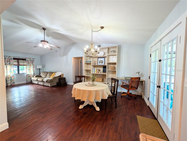 dining room with wood finished floors, vaulted ceiling, and baseboards