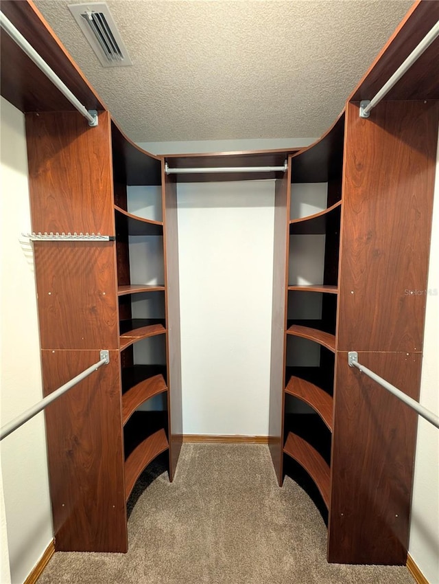 spacious closet featuring carpet flooring and visible vents