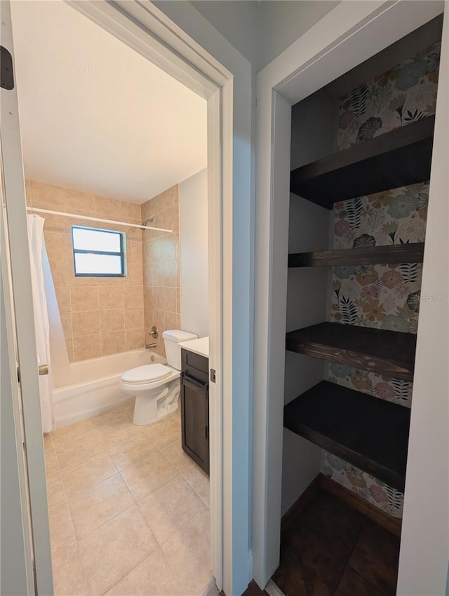 bathroom featuring shower / bath combo with shower curtain, tile patterned flooring, vanity, and toilet