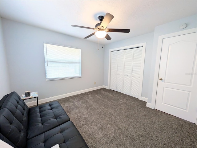 unfurnished room with a ceiling fan, baseboards, and dark carpet