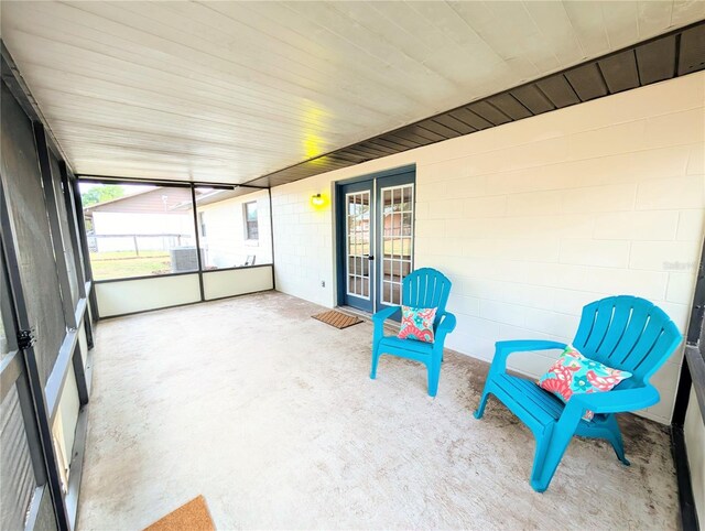 unfurnished sunroom with french doors