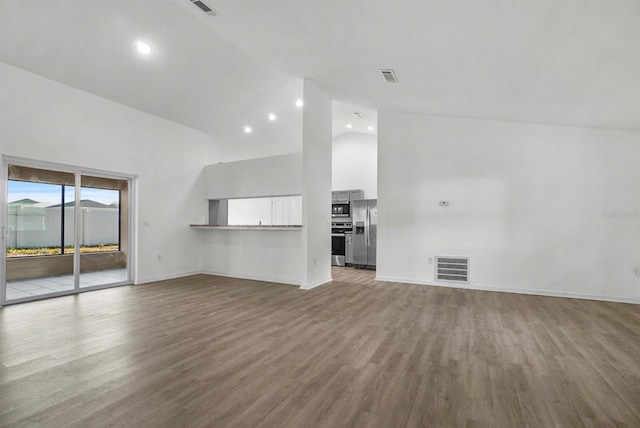4246 NE 32nd Cir, Ocala, FL 34479 - unfurnished living room featuring high vaulted ceiling, visible vents, baseboards, and wood finished floors