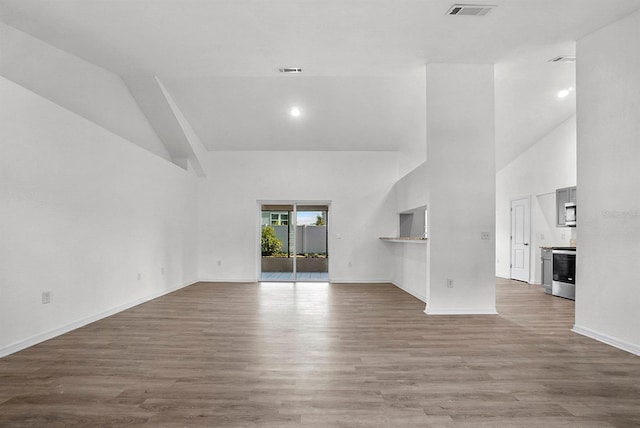 4246 NE 32nd Cir, Ocala, FL 34479 - unfurnished living room with a towering ceiling, baseboards, and wood finished floors
