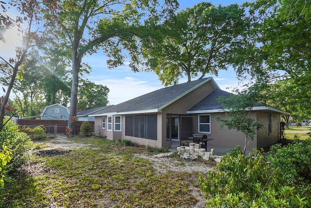 4246 NE 32nd Cir, Ocala, FL 34479 - back of house with a shingled roof, stucco siding, fence, and a patio area