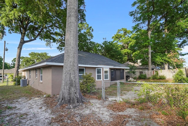 4246 NE 32nd Cir, Ocala, FL 34479 - view of side of home with central AC, stucco siding, fence private yard, and a gate
