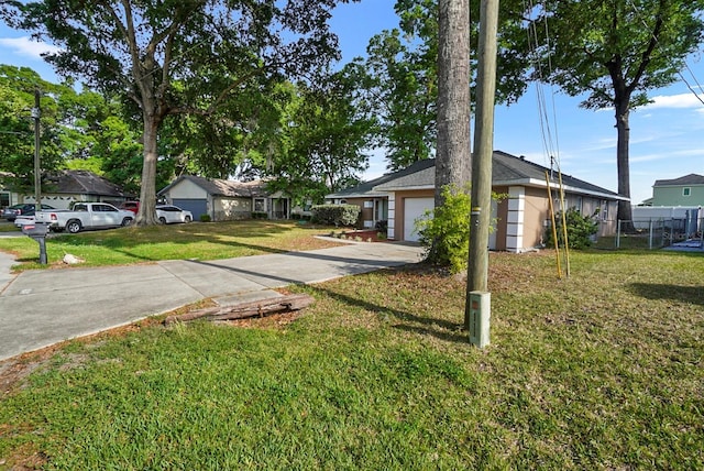 4246 NE 32nd Cir, Ocala, FL 34479 - ranch-style home with driveway, a garage, fence, and a front lawn