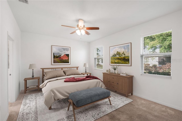 8546 SW 79th Ave, Ocala, FL 34476 - bedroom featuring multiple windows, light colored carpet, baseboards, and a ceiling fan