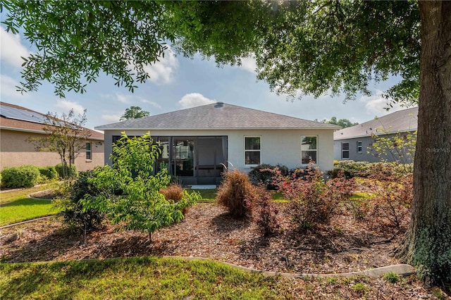 8546 SW 79th Ave, Ocala, FL 34476 - back of house with stucco siding, a sunroom, and roof with shingles