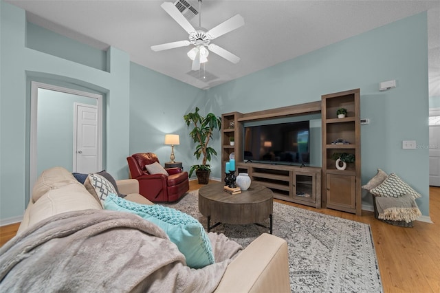 living area featuring ceiling fan, wood finished floors, and visible vents