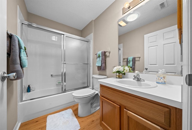 bathroom featuring wood finished floors, visible vents, vanity, and toilet