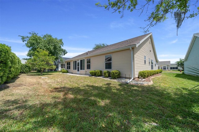 rear view of house with a lawn