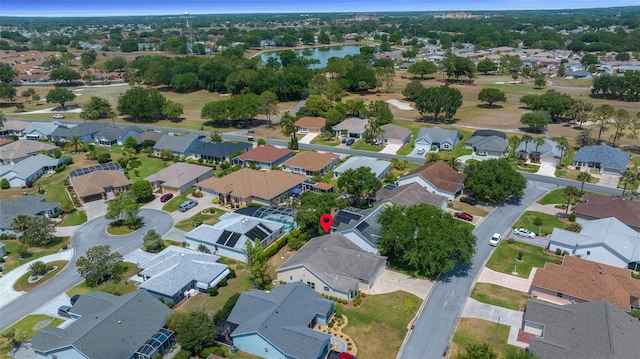 drone / aerial view featuring a residential view and a water view