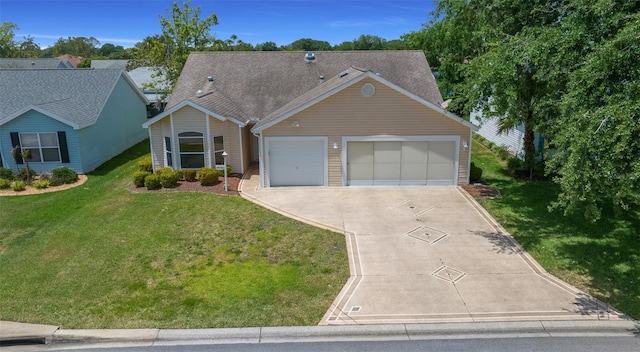 ranch-style house with a garage, a front yard, and concrete driveway