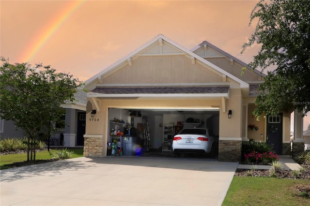 craftsman inspired home featuring concrete driveway, an attached garage, and stone siding