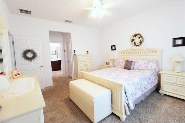 bedroom featuring light colored carpet, visible vents, and a ceiling fan