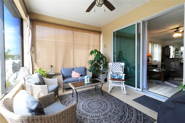 sunroom featuring ceiling fan and an outdoor hangout area
