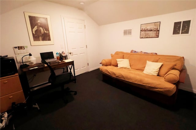 office space with visible vents, vaulted ceiling, dark colored carpet, and baseboards