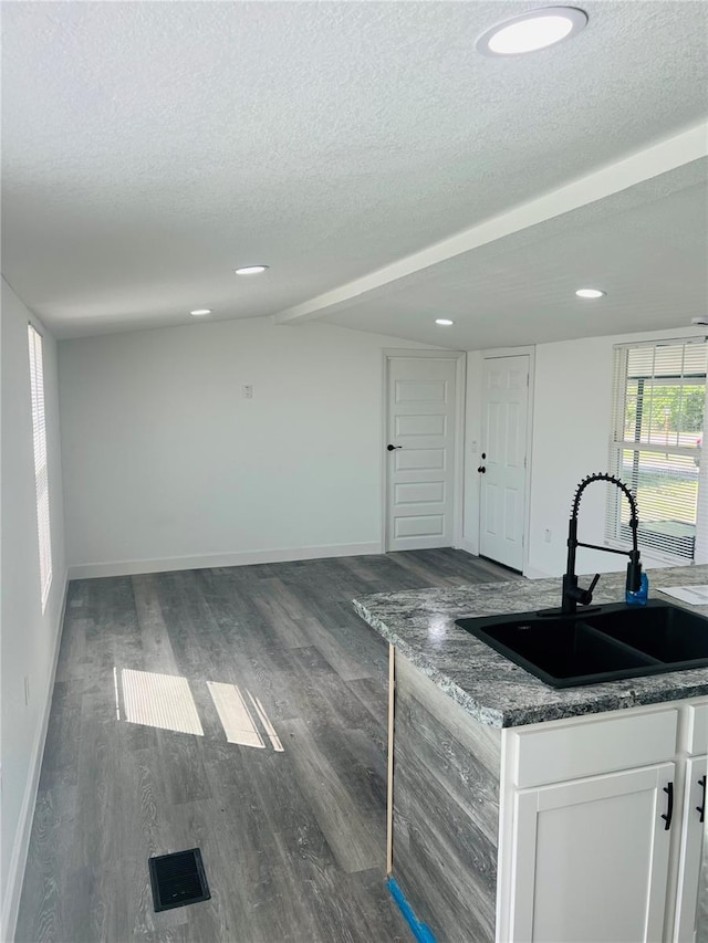 9247 SE 142nd Pl, Summerfield, FL 34491 - kitchen featuring baseboards, a textured ceiling, white cabinets, a sink, and wood finished floors