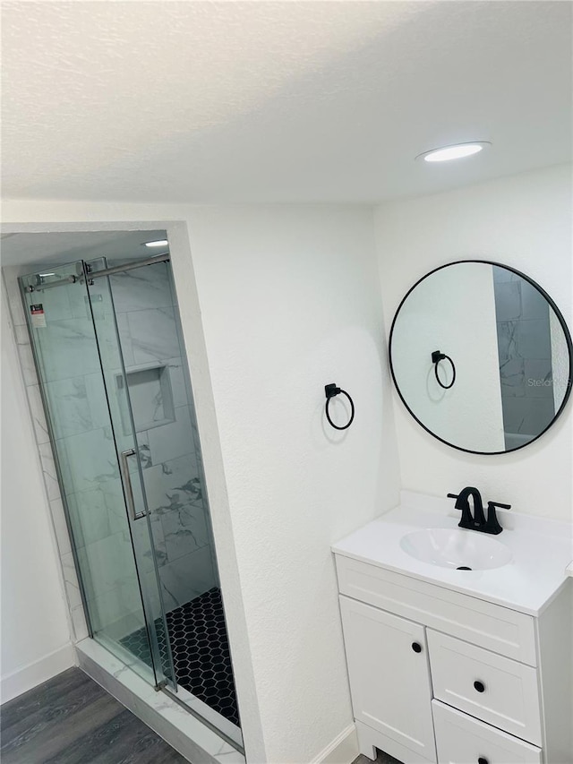 9247 SE 142nd Pl, Summerfield, FL 34491 - bathroom featuring baseboards, a shower stall, vanity, and wood finished floors