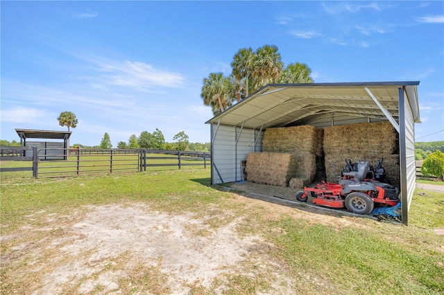 view of vehicle parking featuring a carport and fence