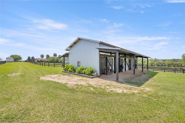view of outdoor structure featuring a rural view, an exterior structure, and an outdoor structure