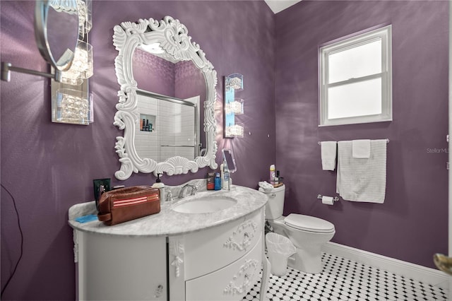 full bath with baseboards, toilet, a shower stall, vanity, and tile patterned floors