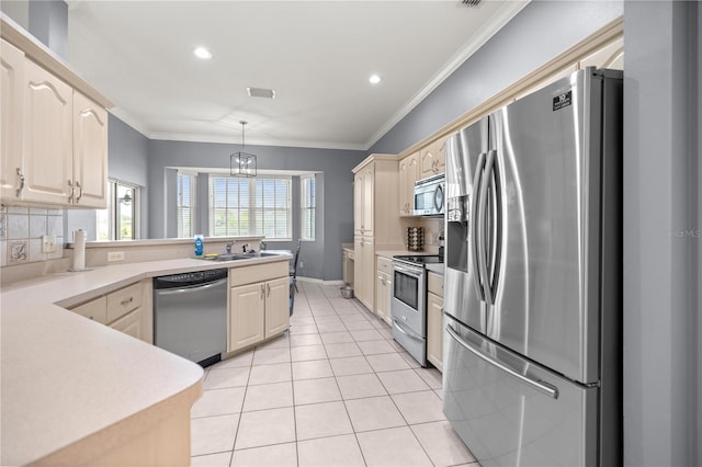kitchen featuring tasteful backsplash, a peninsula, crown molding, light tile patterned flooring, and appliances with stainless steel finishes