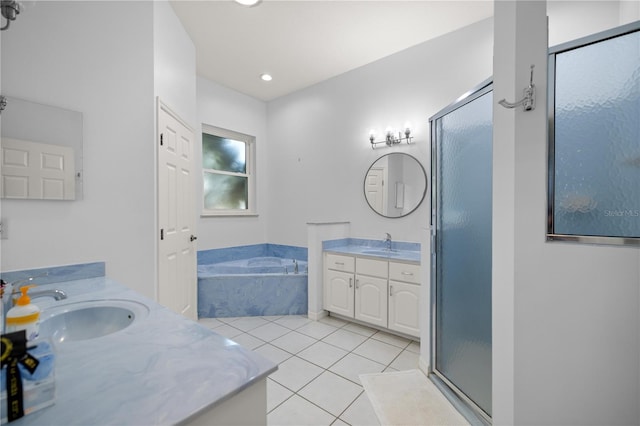 full bath with a sink, tile patterned floors, a shower stall, and two vanities