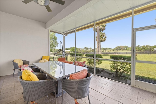 sunroom / solarium with plenty of natural light, outdoor dining area, and ceiling fan