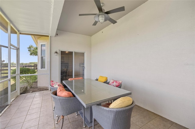 sunroom featuring ceiling fan