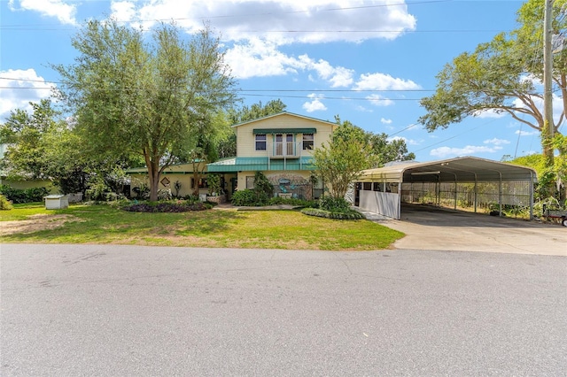 31 SE Chinica Dr, Summerfield, FL 34491 - view of front of property featuring a carport, concrete driveway, and a front lawn