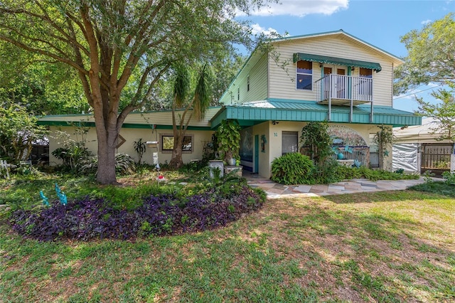 31 SE Chinica Dr, Summerfield, FL 34491 - view of front of house with a balcony and stucco siding