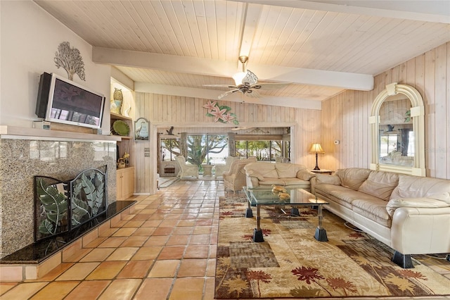 31 SE Chinica Dr, Summerfield, FL 34491 - living area featuring wooden walls, a ceiling fan, a premium fireplace, and a wood ceiling with exposed beams