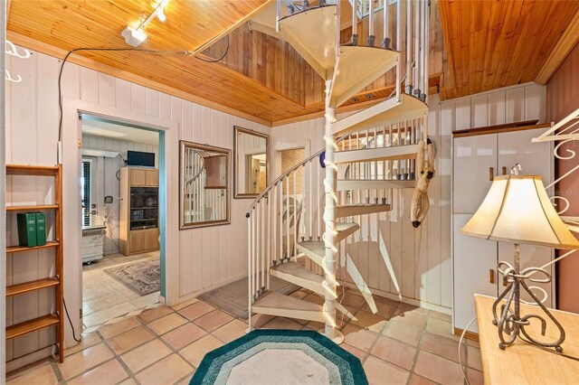 31 SE Chinica Dr, Summerfield, FL 34491 - staircase featuring wood ceiling, tile patterned floors, and wood walls