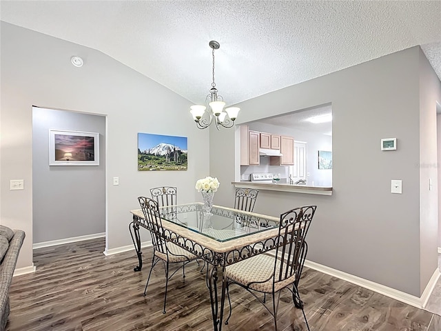 dining space featuring a textured ceiling, a chandelier, baseboards, lofted ceiling, and dark wood-type flooring
