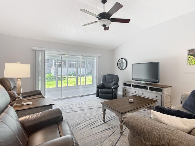 living area featuring baseboards, a ceiling fan, carpet, and lofted ceiling