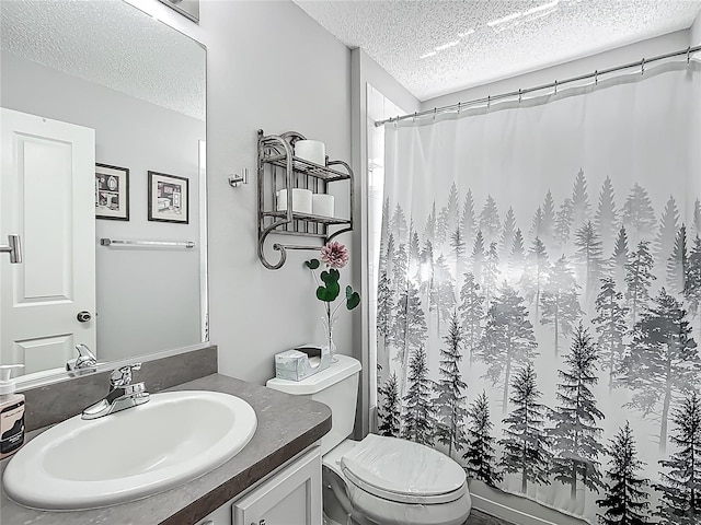 bathroom featuring vanity, a shower with curtain, toilet, and a textured ceiling