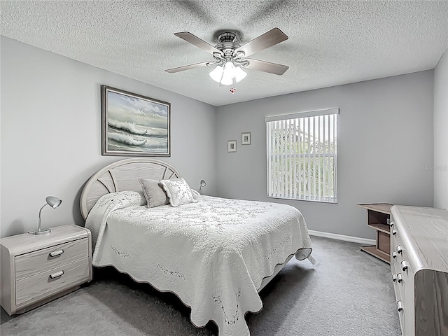 bedroom with baseboards, carpet flooring, a textured ceiling, and ceiling fan