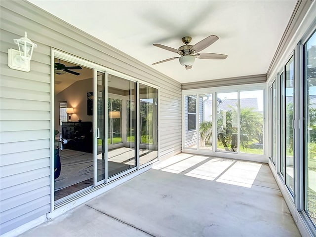unfurnished sunroom with plenty of natural light and ceiling fan