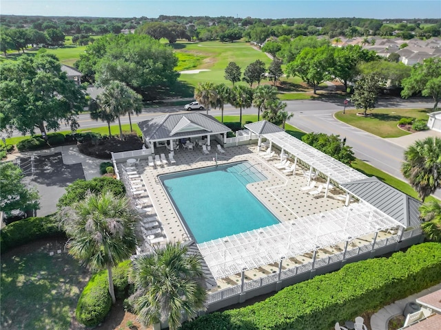 community pool featuring a gazebo, golf course view, fence, and a patio