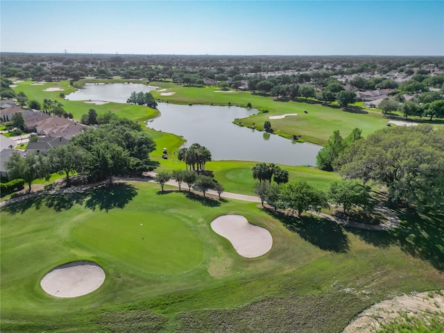 drone / aerial view featuring a water view, golf course view, and a residential view
